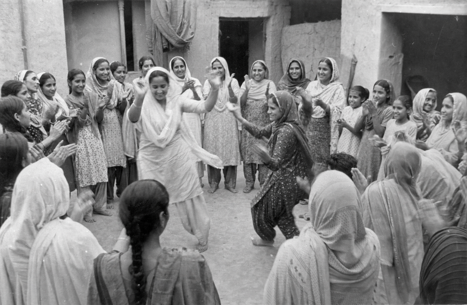 Vintage photograph of women dancing gidha in a circle
