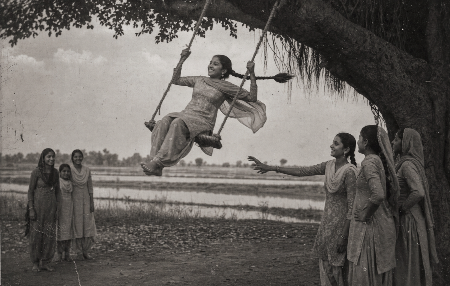 Vintage photograph of a Punjabi girl on a peengh swing under a tree