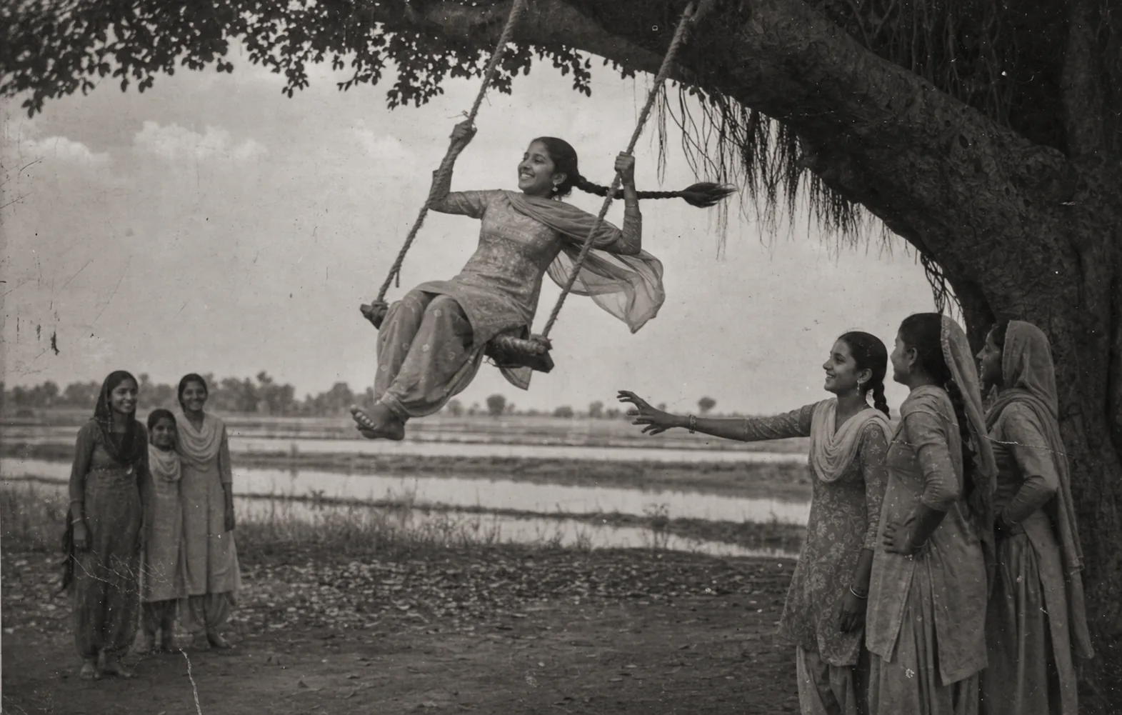 A young Punjabi girl on a rope-and-plank peengh swing under a jand tree, dupatta trailing